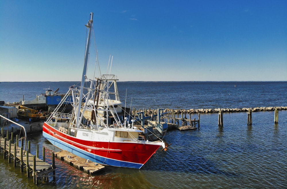 white and blue boat on sea during daytime