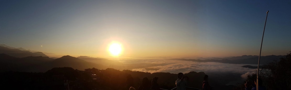 Sunrise over Roraima landscape with people connecting under a bright yellow sun logo