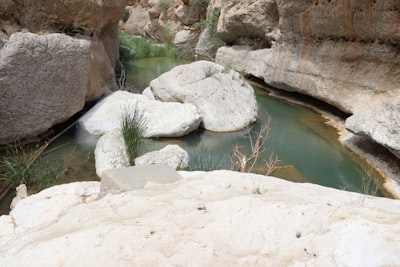 white rock formation beside body of water during daytime somalia teams background