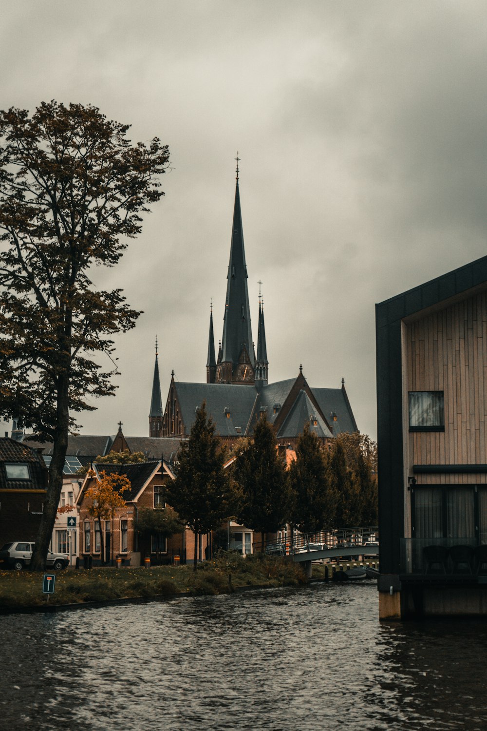 bâtiment en béton brun et blanc près d’arbres verts sous des nuages blancs pendant la journée