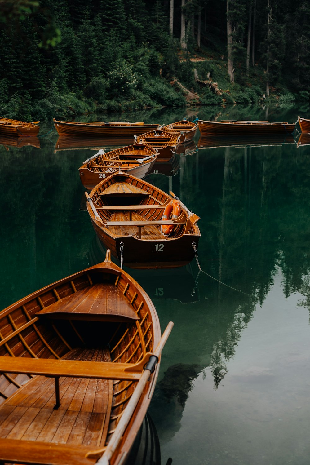 brown wooden boat on body of water during daytime