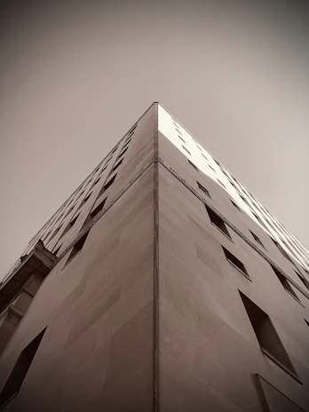 Sharp angled view of a corporate building facade emphasizing order and strategic design.