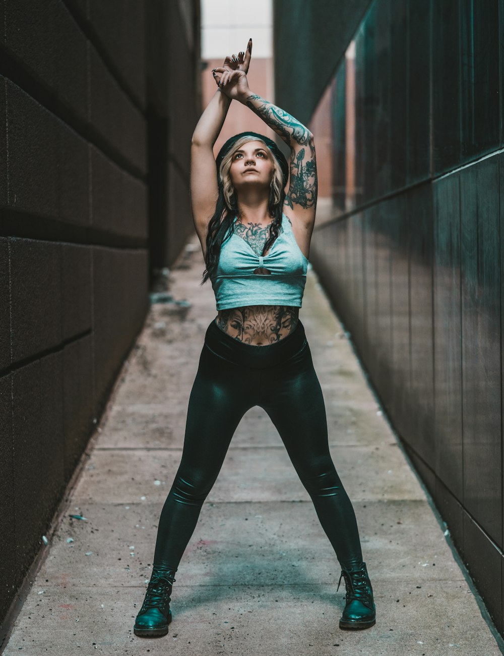 woman in black sports bra and black leggings standing on tunnel