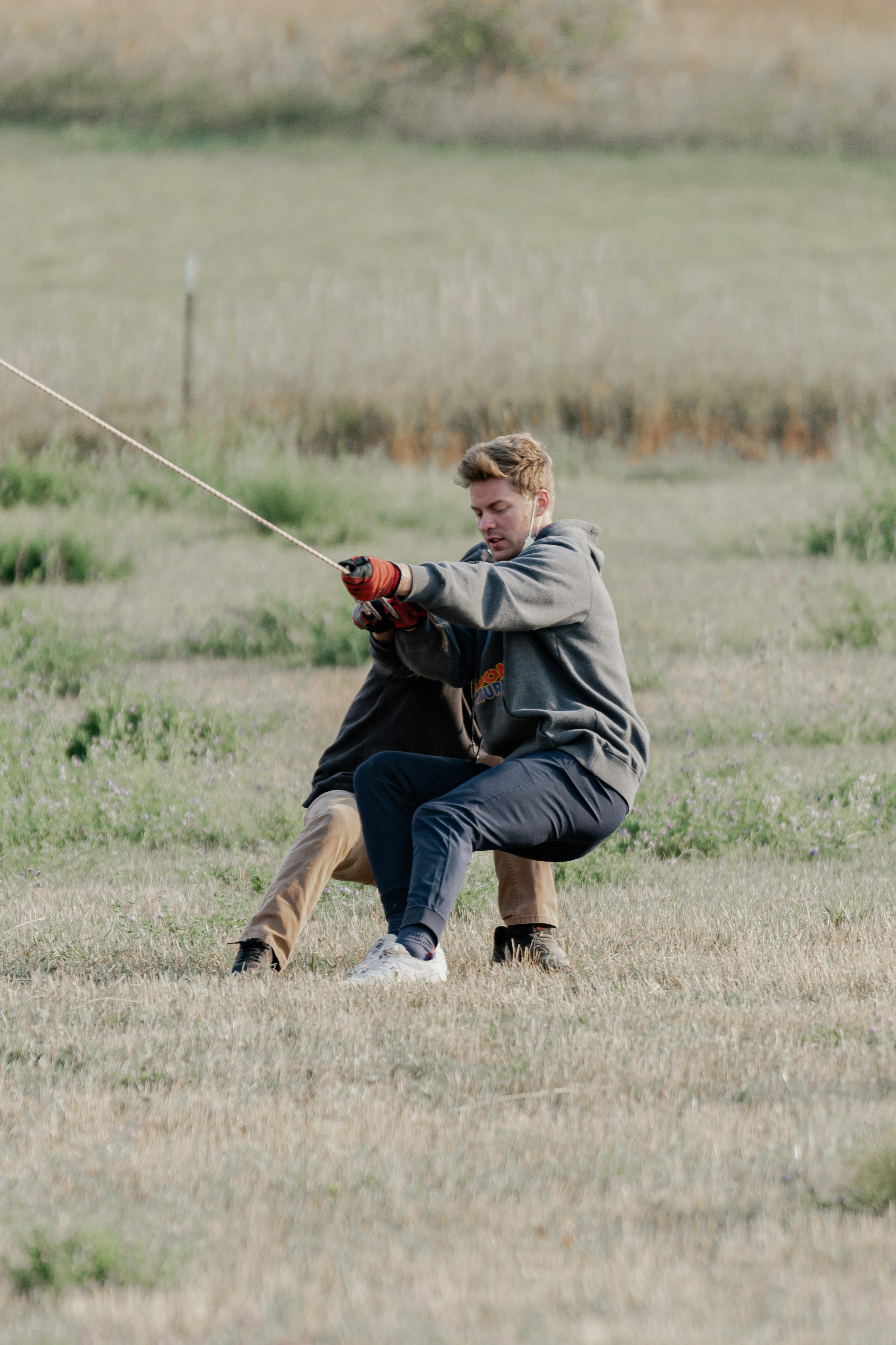 A man is flying a kite in a field photo – Free Human Image on Unsplash