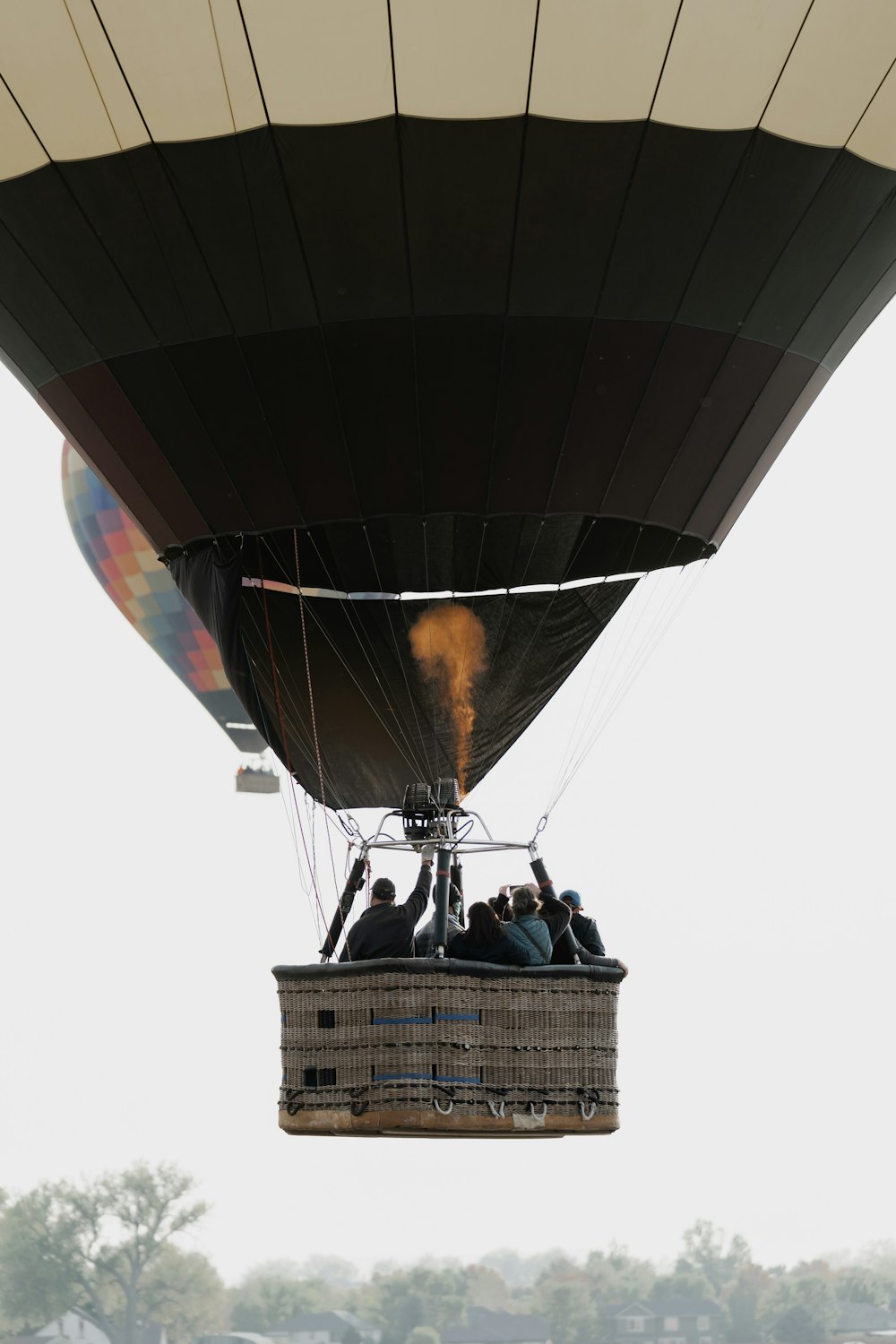3 men standing on hot air balloon