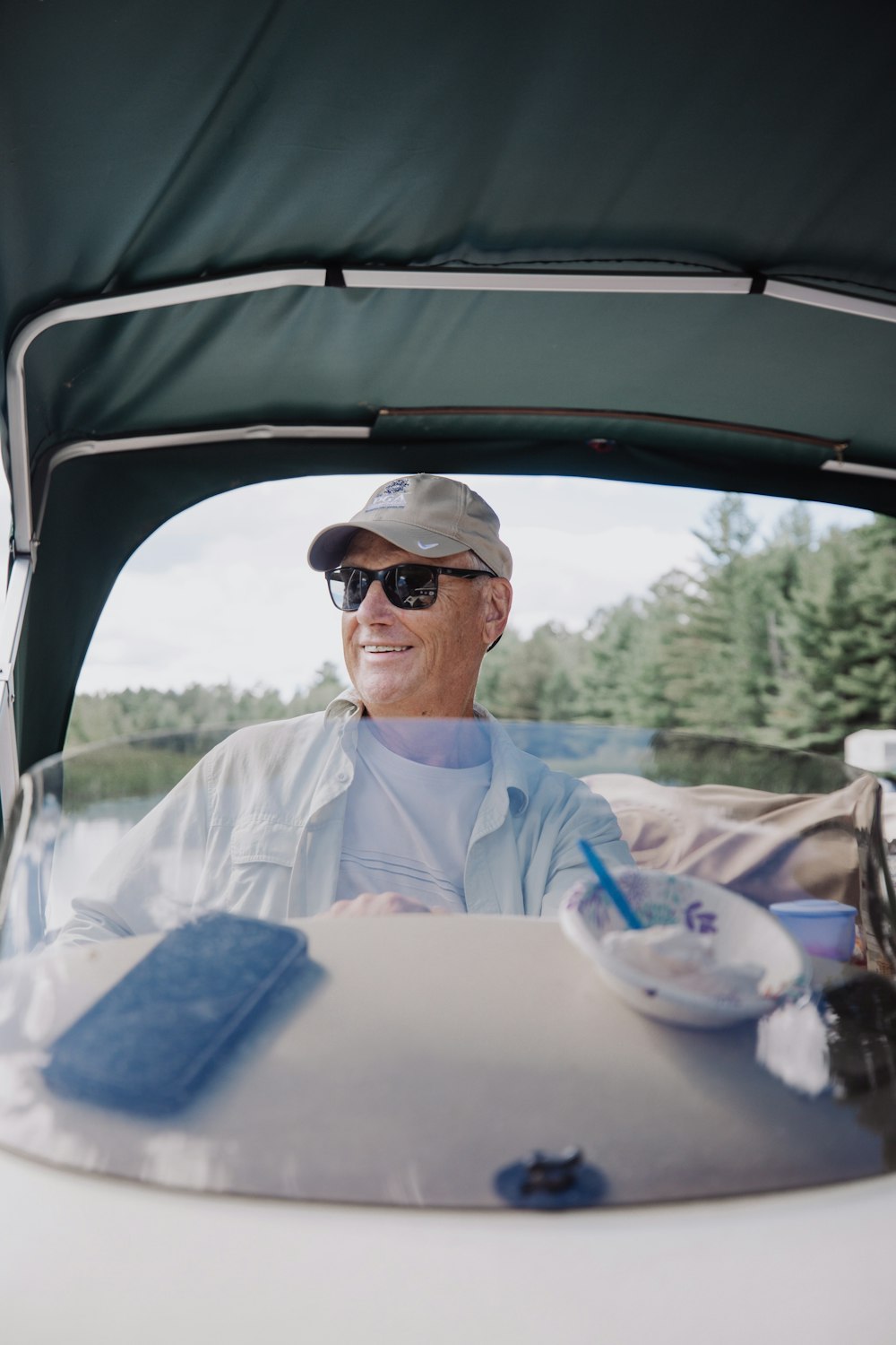 man in white button up shirt wearing black sunglasses sitting on car seat during daytime