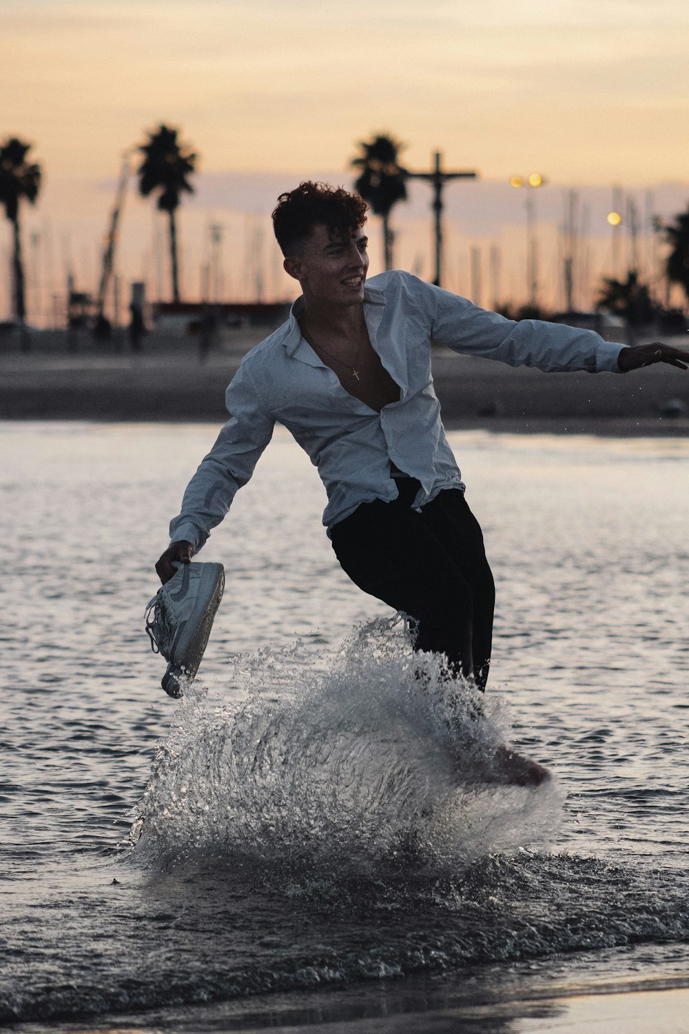 man in white dress shirt and black pants holding blue plastic bag