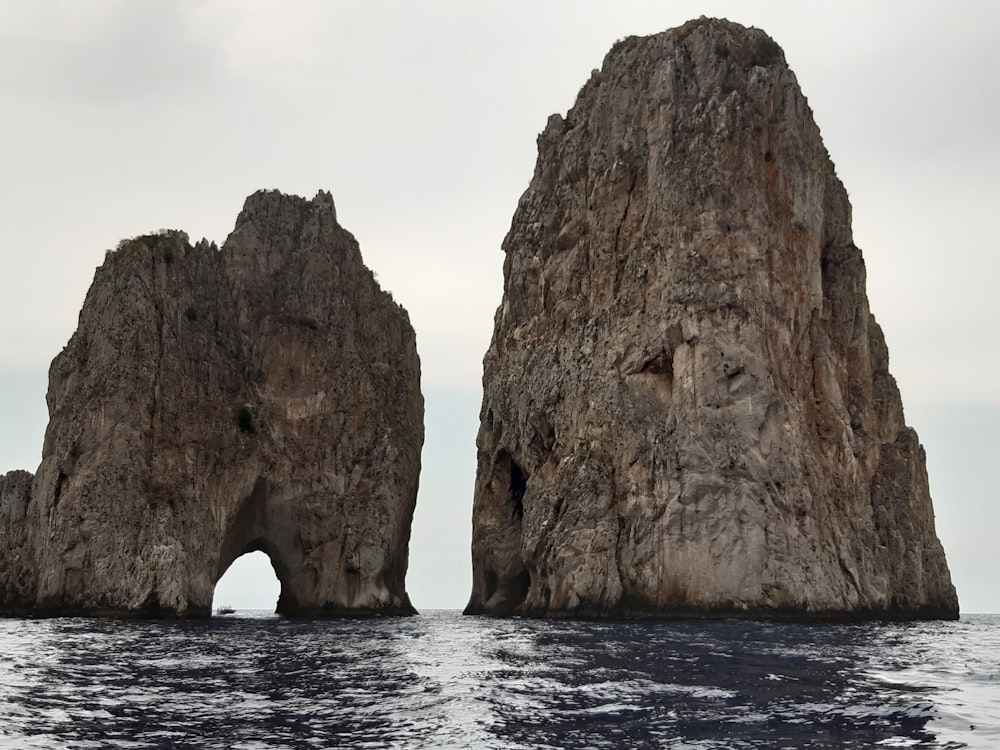 brown rock formation on sea during daytime