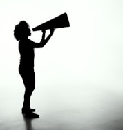 silhouette of woman holding rectangular board