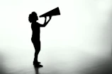 silhouette of woman holding rectangular board