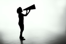 silhouette of woman holding rectangular board