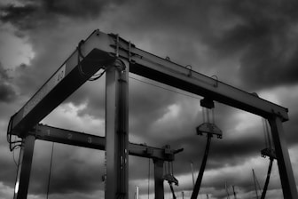grayscale photo of metal crane
