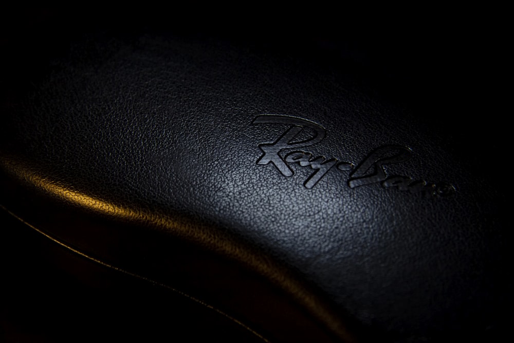 black leather textile with white logo