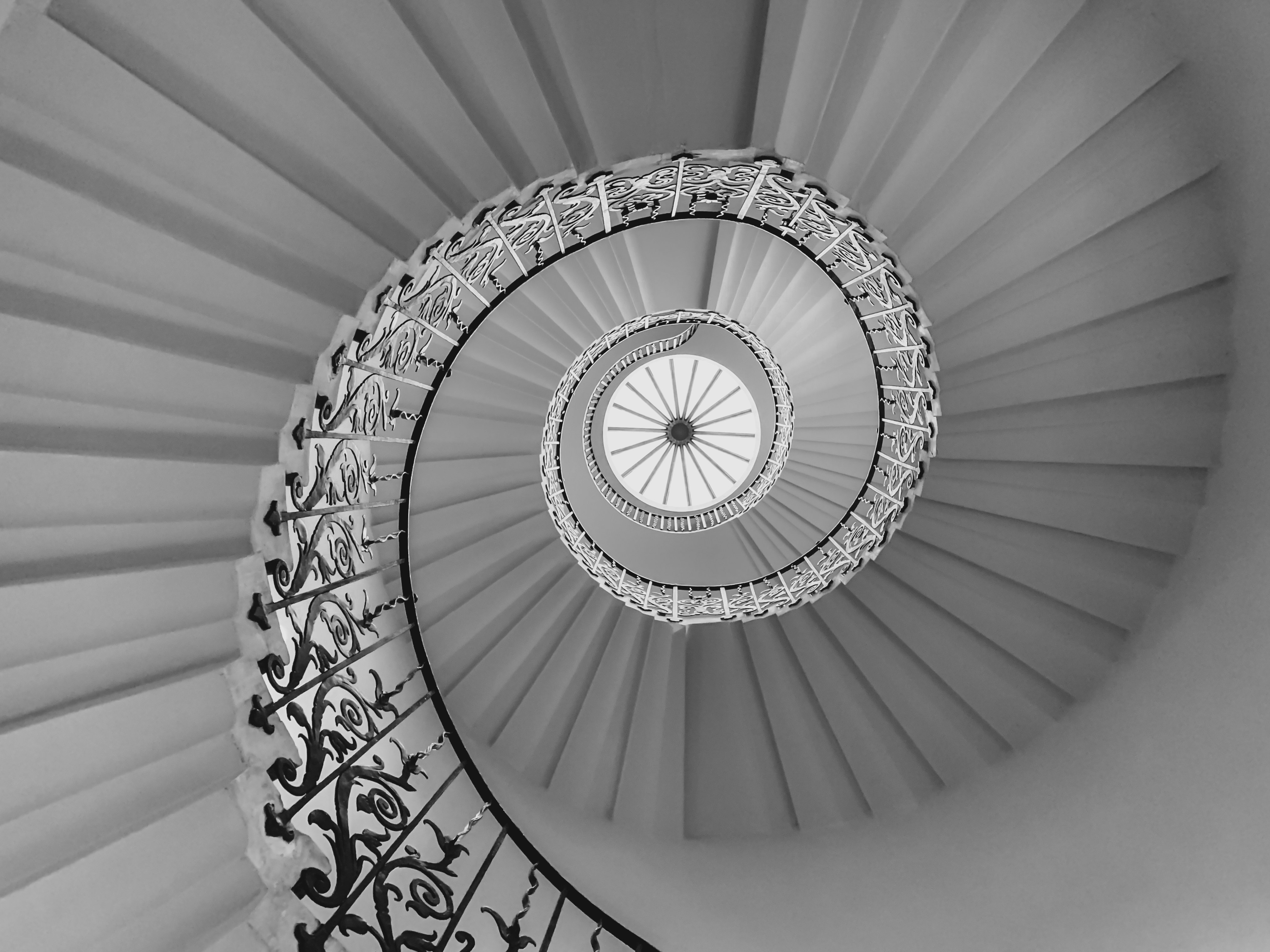 white spiral staircase with white metal railings