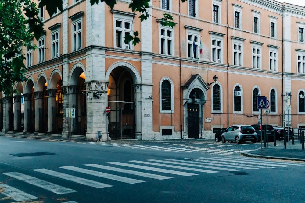 cars parked in front of brown building