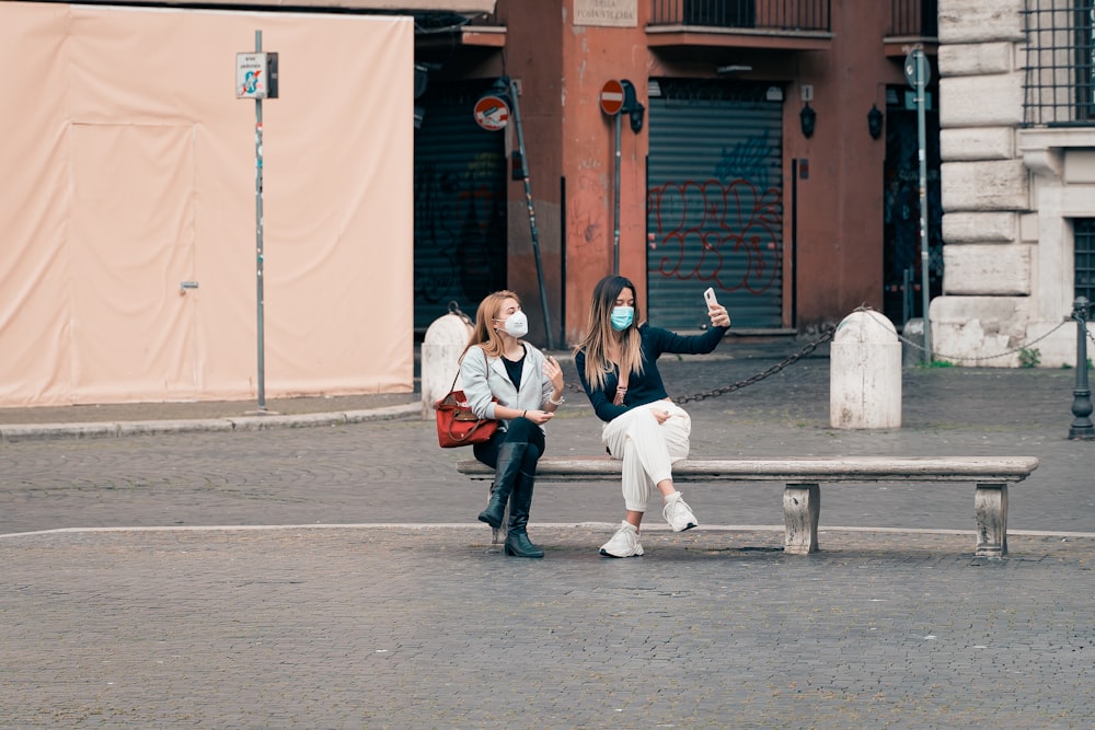 3 women sitting on concrete bench