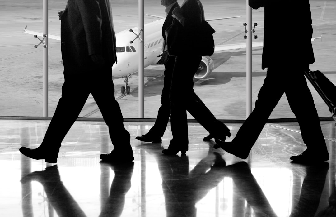man in black pants and black jacket walking on ice covered ground,