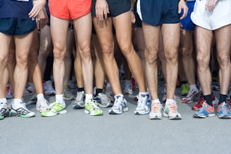 man in blue shorts and white nike sneakers