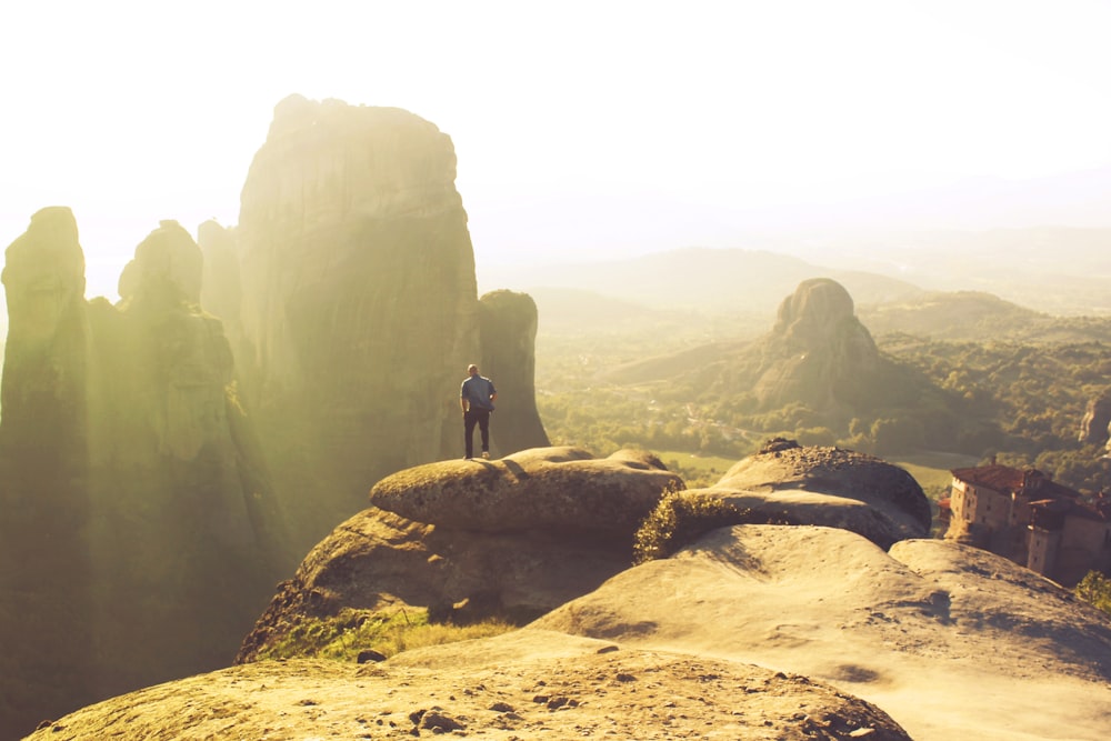 person standing on rock formation during daytime