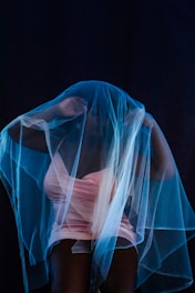 white sheer textile on blue textile