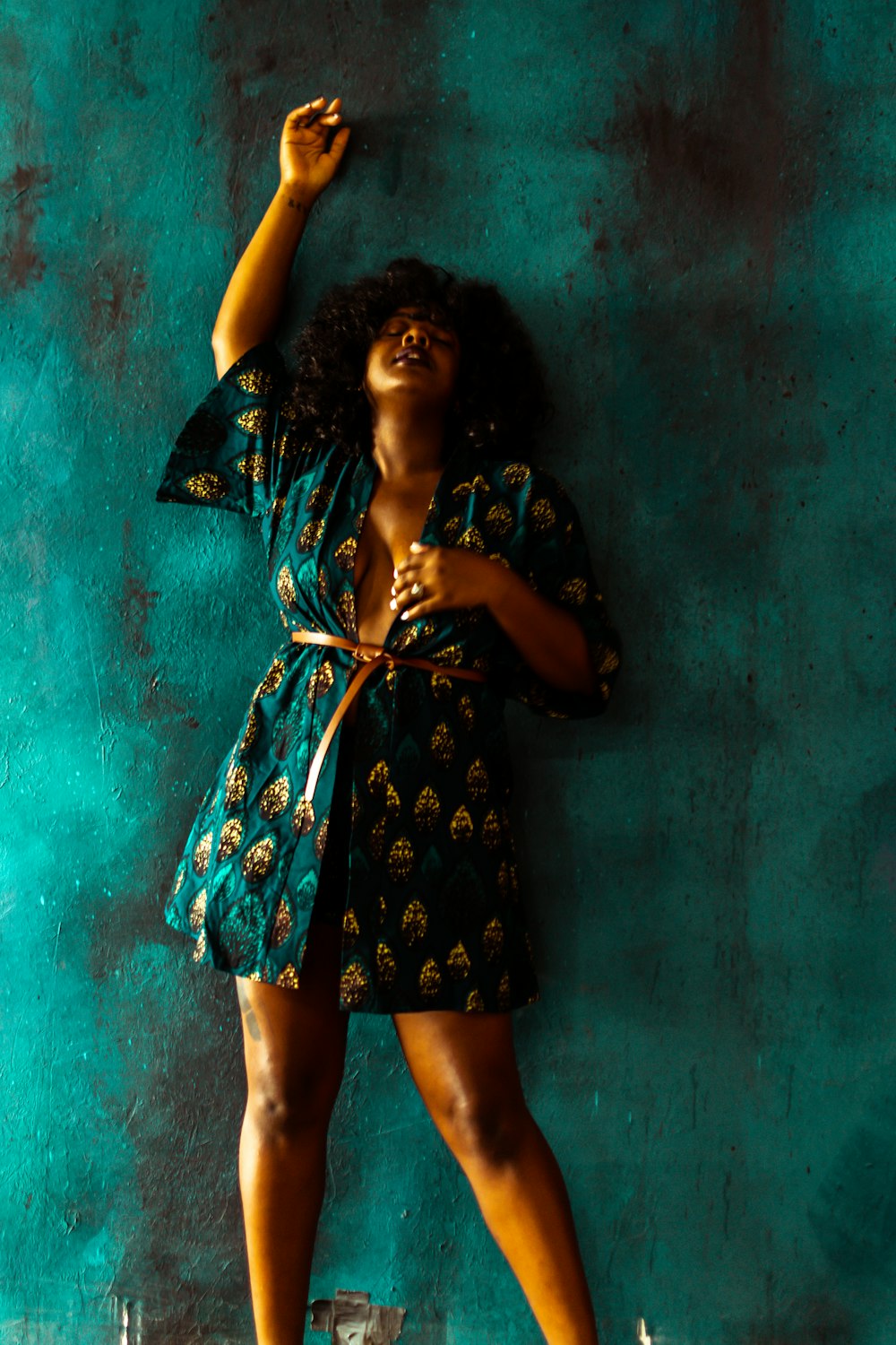 woman in blue and white polka dot dress holding umbrella