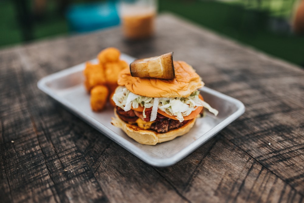 burger with cheese on white ceramic tray