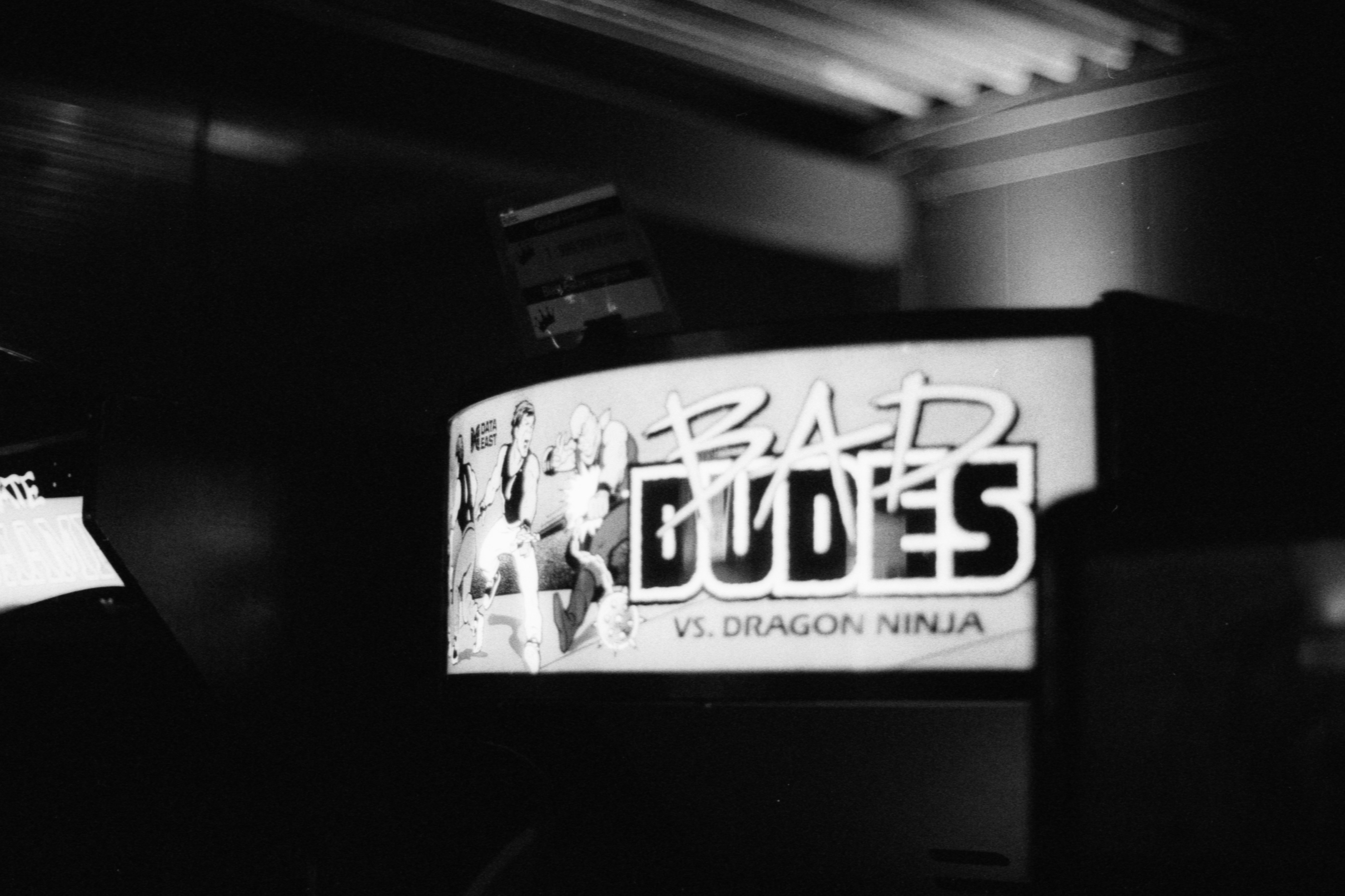 a black and white photo of a sign that reads dead dudes