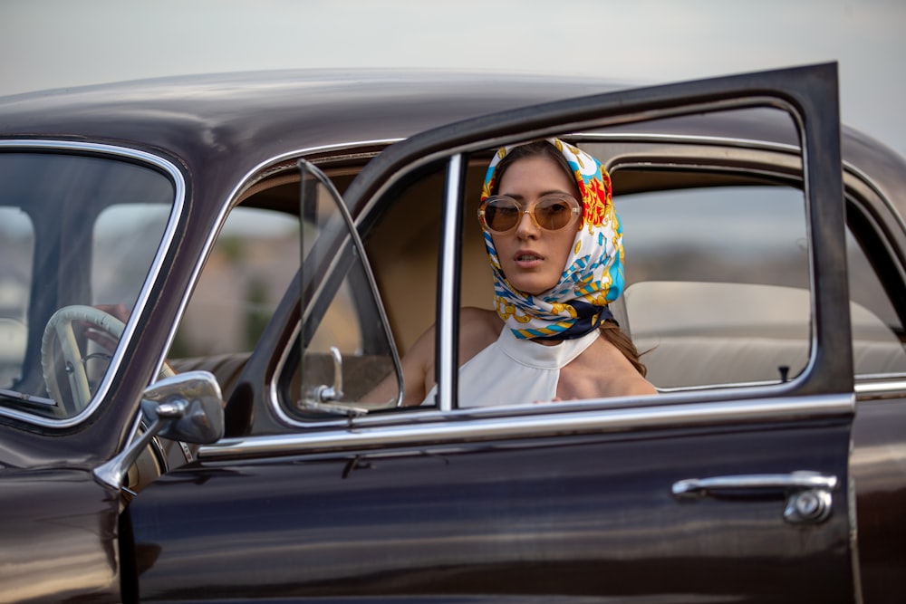 woman in white sleeveless dress wearing brown sunglasses