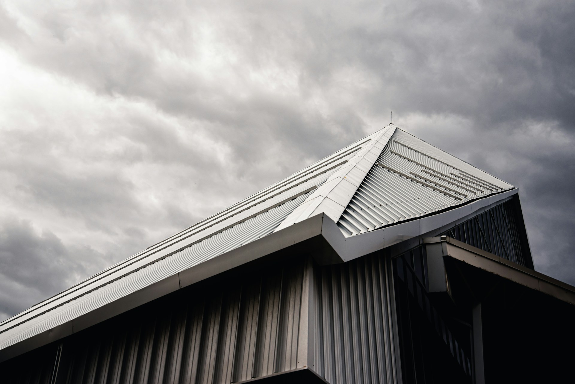 gray and white wooden house under white clouds