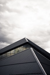 gray and black building under white clouds