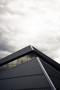 gray and black building under white clouds