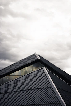 gray and black building under white clouds