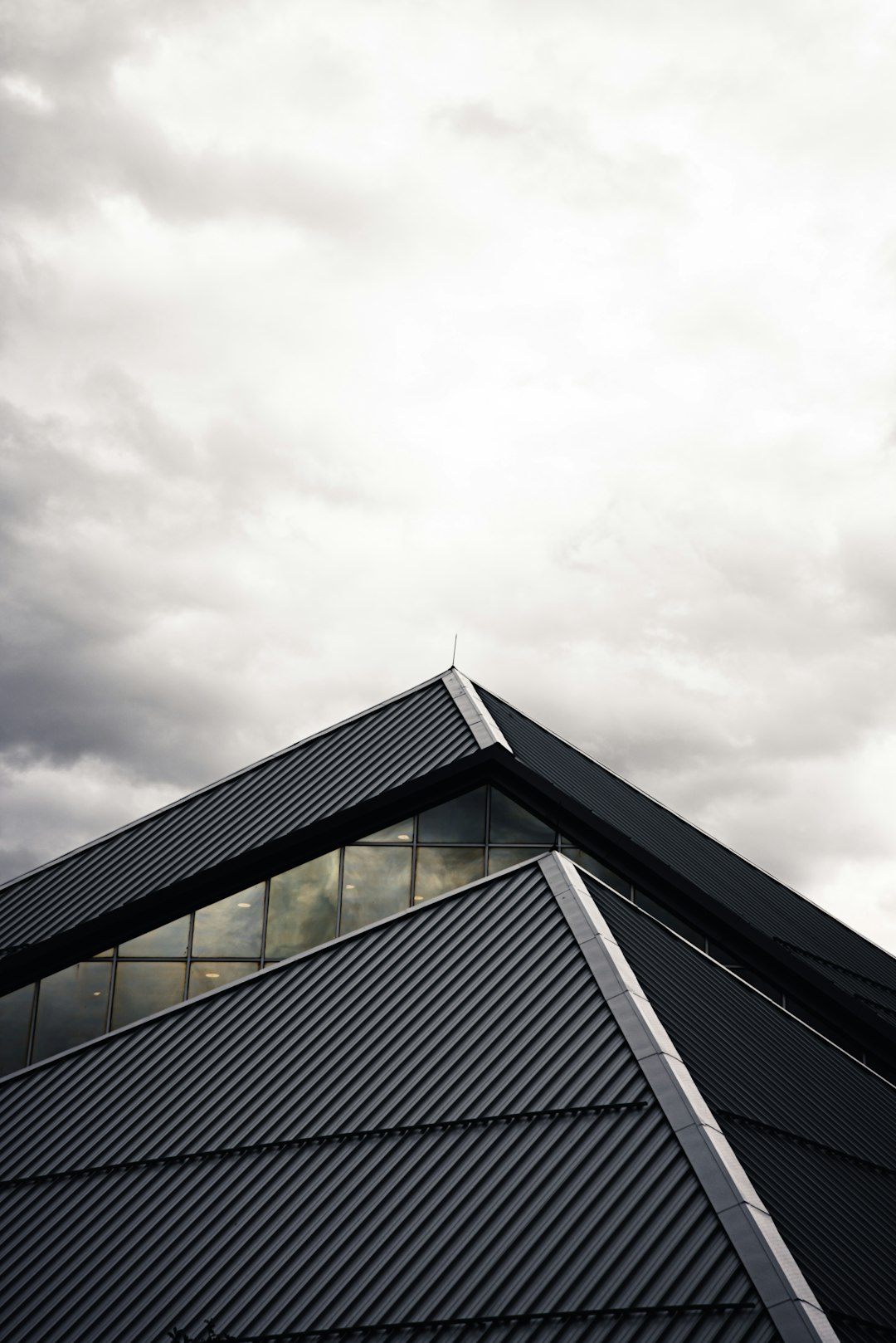  gray and black building under white clouds roof