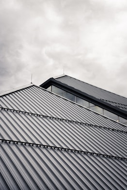 gray and black building under white clouds