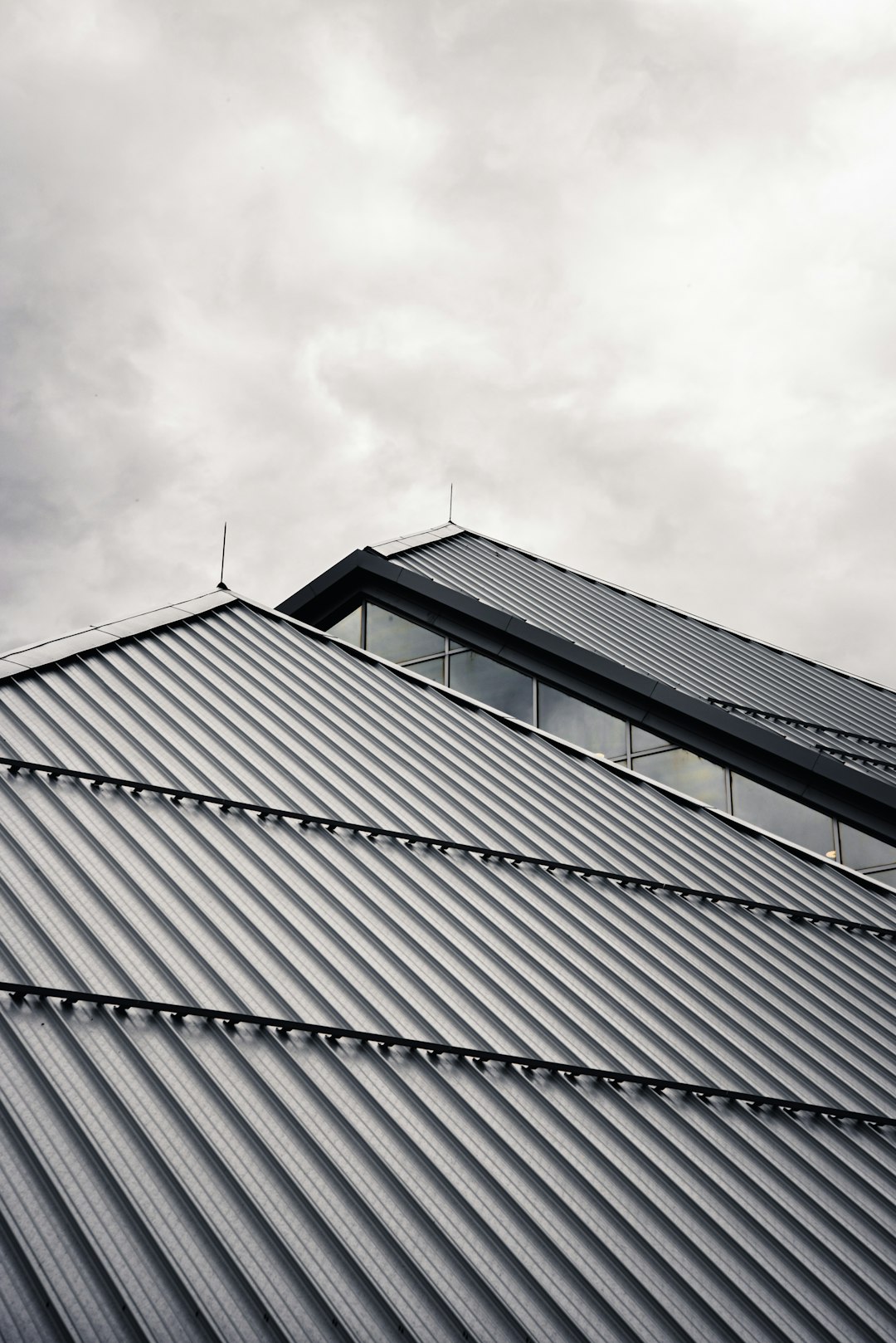 gray and black building under white clouds