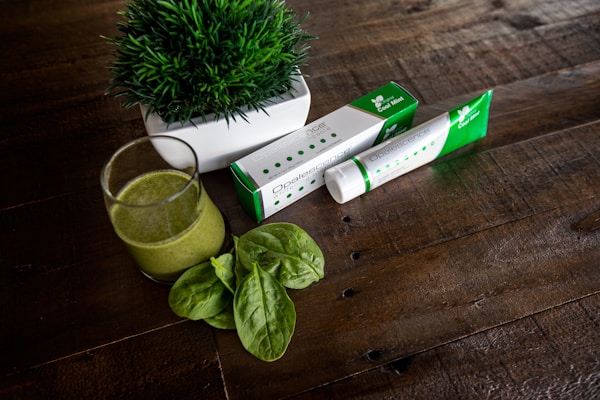 Green leaf beside white and green box