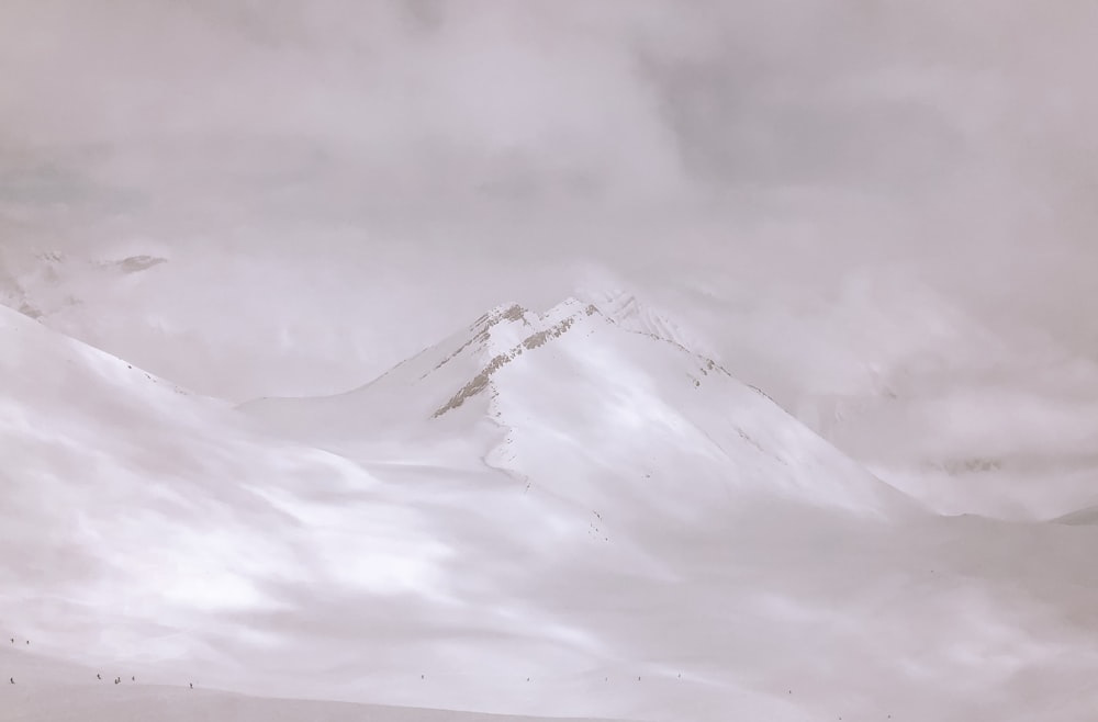 snow covered mountain under cloudy sky during daytime