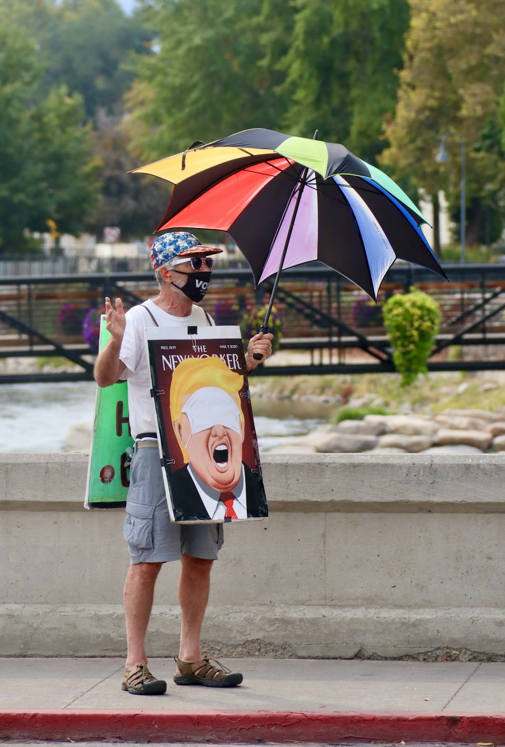 woman in white crew neck t-shirt holding umbrella