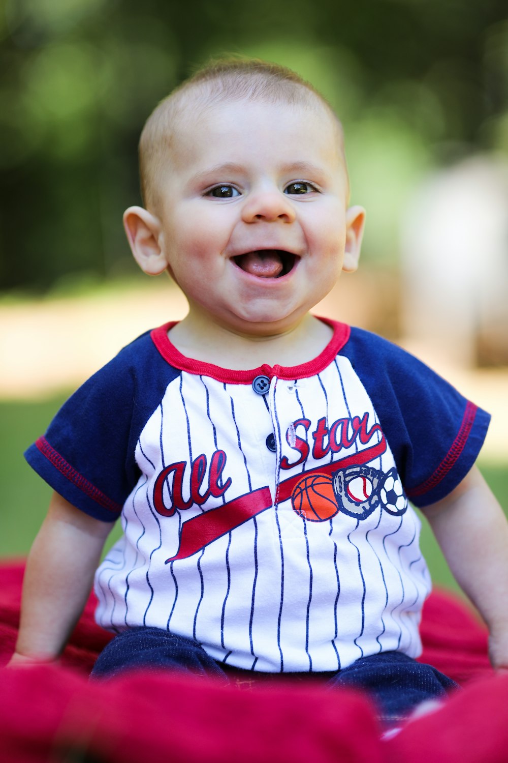 boy in blue and white adidas jersey shirt smiling