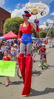 Stilt walker dressed in vibrant colors entertaining guests at a lively festival