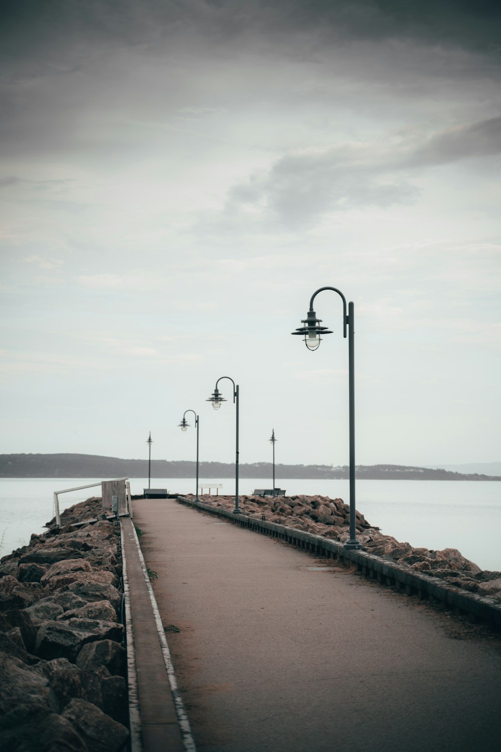 black steel light post on brown concrete dock during daytime