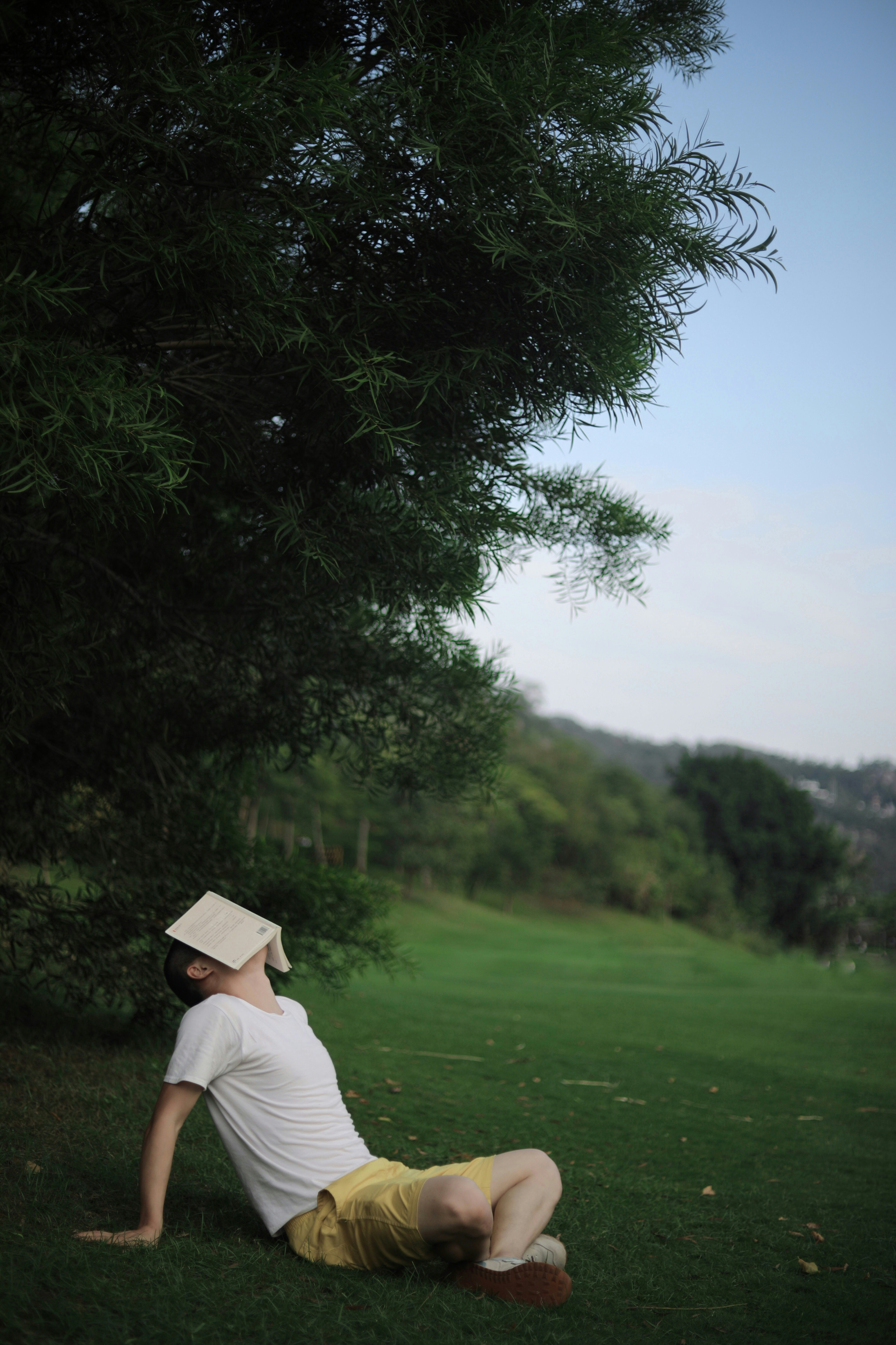 man in white shirt standing on green grass field during daytime