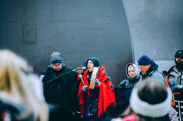 A diverse group of people from the northern region gathered in a community meeting, sharing stories and support.