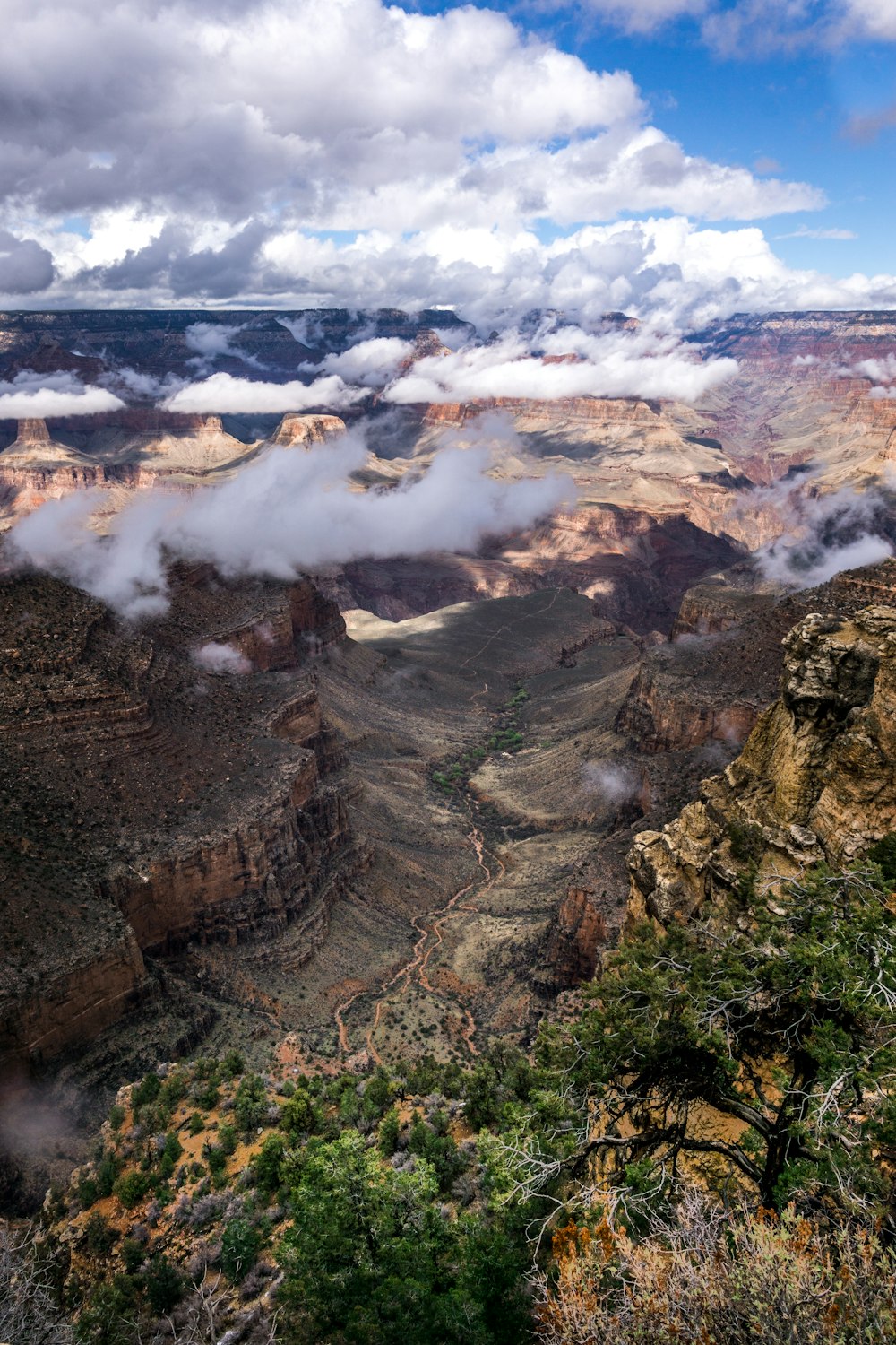 brown rocky mountain with white clouds