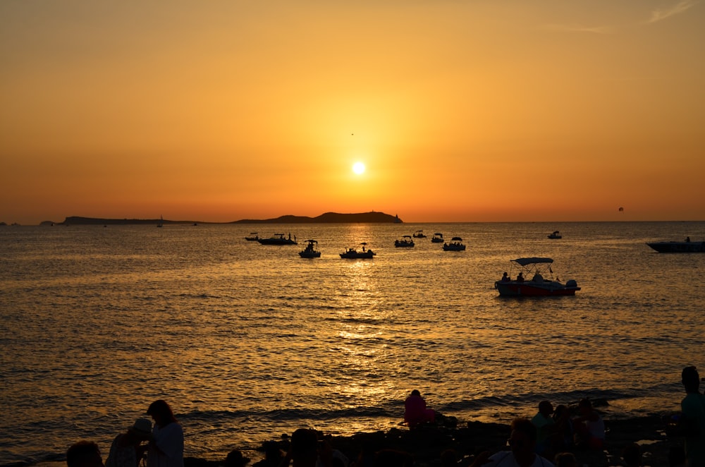 silhouette of people on beach during sunset