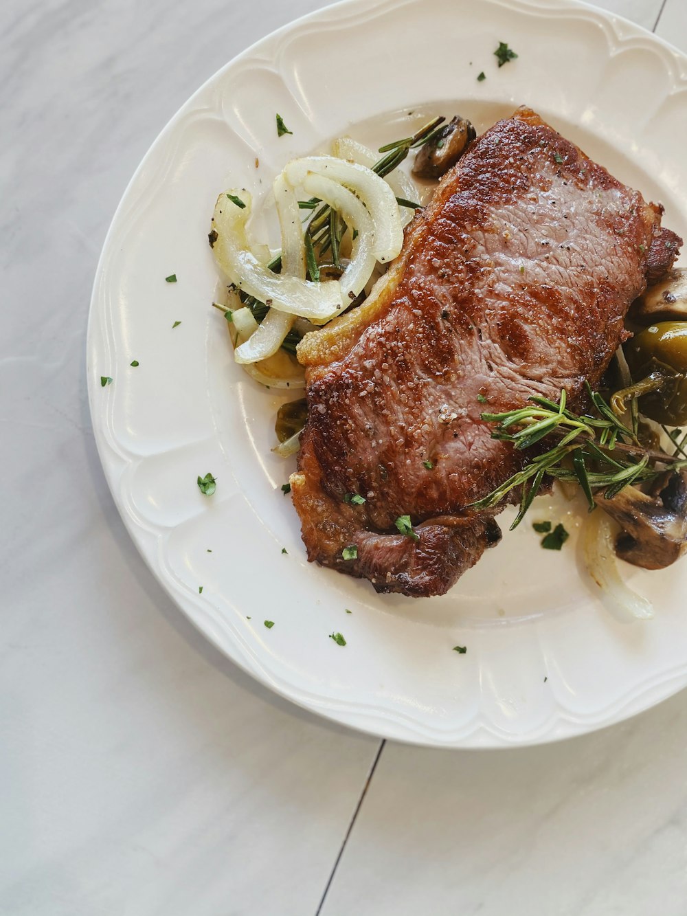 cooked meat on white ceramic plate