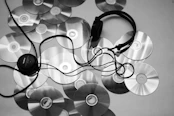 black corded headphones on white surface
