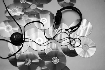 black corded headphones on white surface
