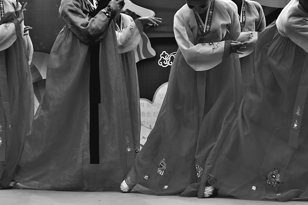 grayscale photo of man and woman holding hands