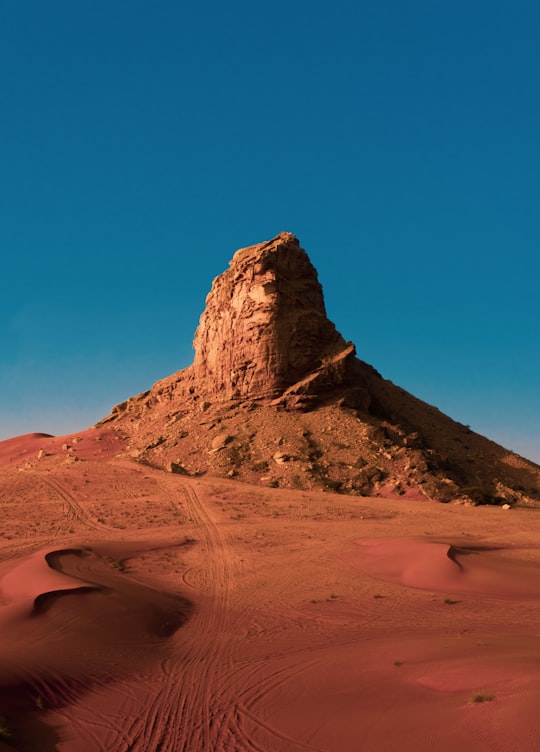 brown rocky mountain under blue sky during daytime in Sharjah United Arab Emirates
